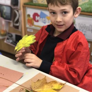 child who painted leaf yellow