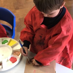 student painting a leaf