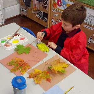 child painting leaf